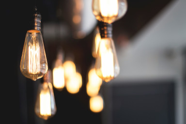 Old style light bulbs hanging from a ceiling.